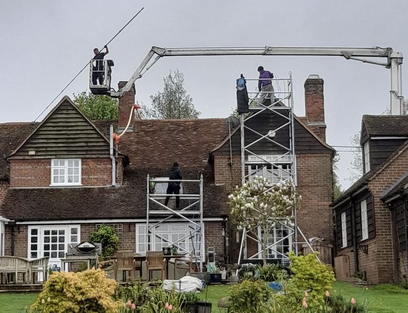 The Moss Cleaners using cherry picker and scaffolding to clean roof safely and professionally in 1 Almond Ave, Ickenham, Uxbridge UB10 8NA, UK, 1 Almond Ave, Ickenham, Uxbridge UB10 8NA, UK